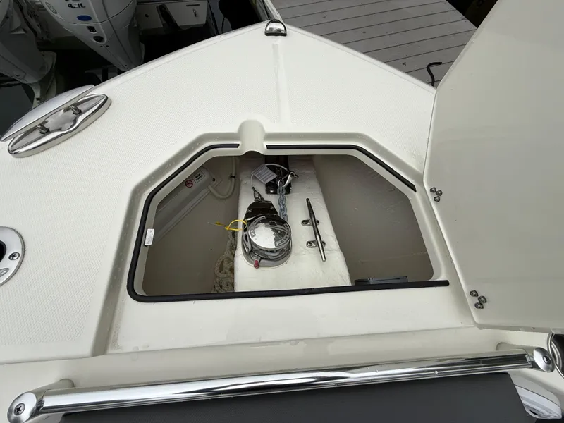 Slide: The Image of Open storage compartment on 2025 Cobia 265 Open Center Console boat. - 17