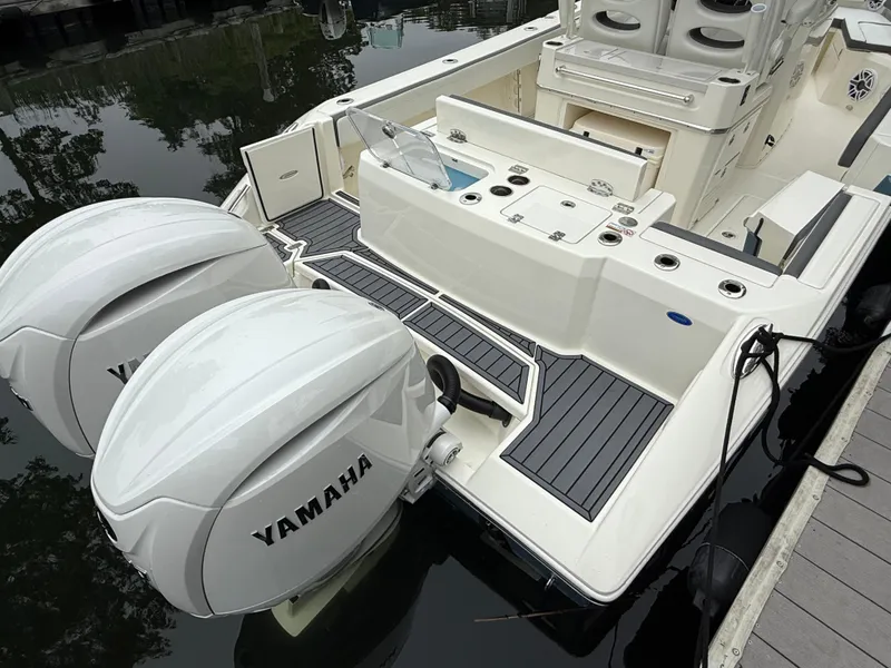 Slide: The Image of 2025 Cobia 265 Open Center Console with twin Yamaha outboards docked. - 3