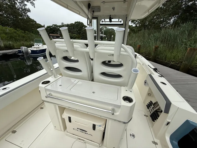 Slide: The Image of 2025 Cobia 265 Open Center Console boat with rod holders and storage. - 7