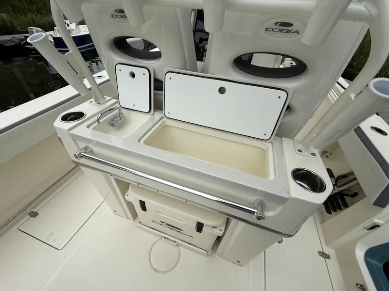 Slide: The Image of 2025 Cobia 265 Open Center Console boat with sink and storage compartments. - 8