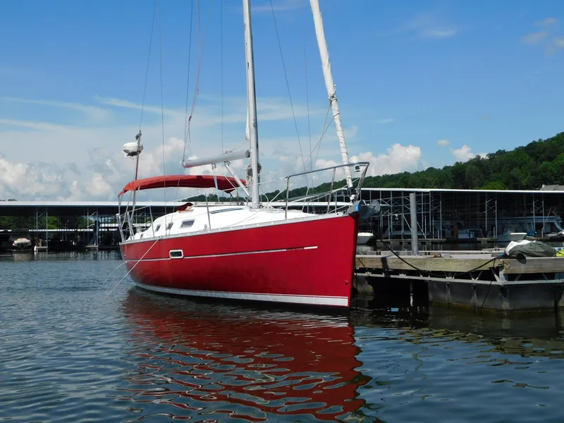 Slide: The Image of Red 2005 Beneteau Oceanis Clipper 323 sailboat docked at marina under blue sky. - 10