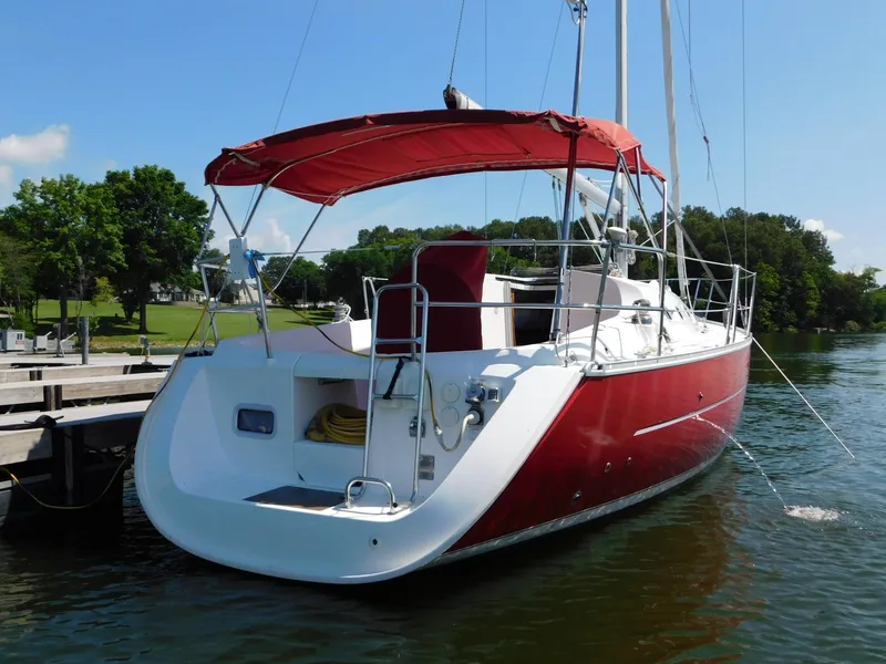 Slide: The Image of Red 2005 Beneteau Oceanis Clipper 323 sailboat docked on a sunny day. - 14