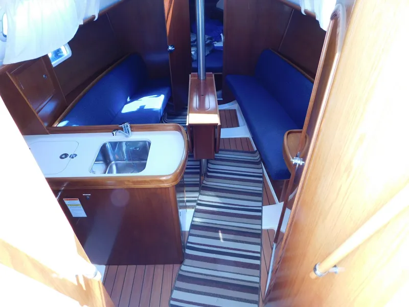 Slide: The Image of Interior of 2005 Beneteau Oceanis Clipper 323 sailboat with wood finish and compact kitchen. - 28