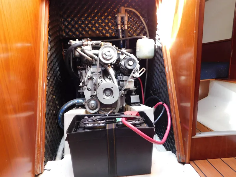 Slide: The Image of Engine compartment of 2005 Beneteau Oceanis Clipper 323 sailboat, featuring visible engine and battery. - 38