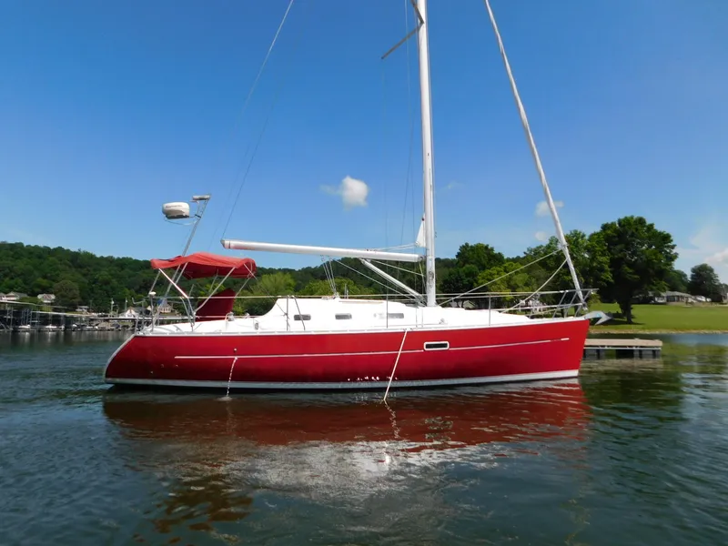 Slide: The Image of Red 2005 Beneteau Oceanis Clipper 323 sailboat on calm water, clear sky background. - 5