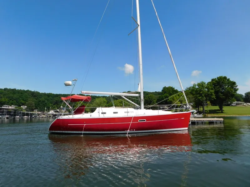 Slide: The Image of Red 2005 Beneteau Oceanis Clipper 323 sailboat docked on a sunny day. - 6