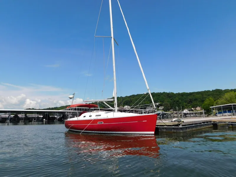 Slide: The Image of Red 2005 Beneteau Oceanis Clipper 323 sailboat docked on a sunny day. - 9