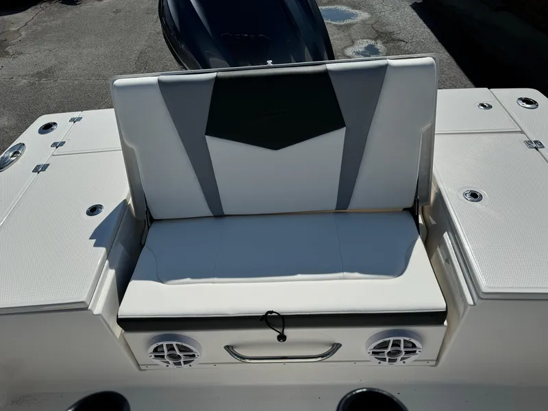 Slide: The Image of 2025 Robalo R246 CAYMAN boat seating area with integrated speakers and storage compartments. - 14
