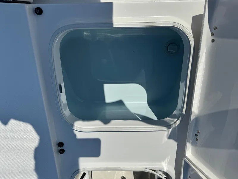 Slide: The Image of 2025 Robalo R246 CAYMAN boat storage compartment, open and empty. - 6