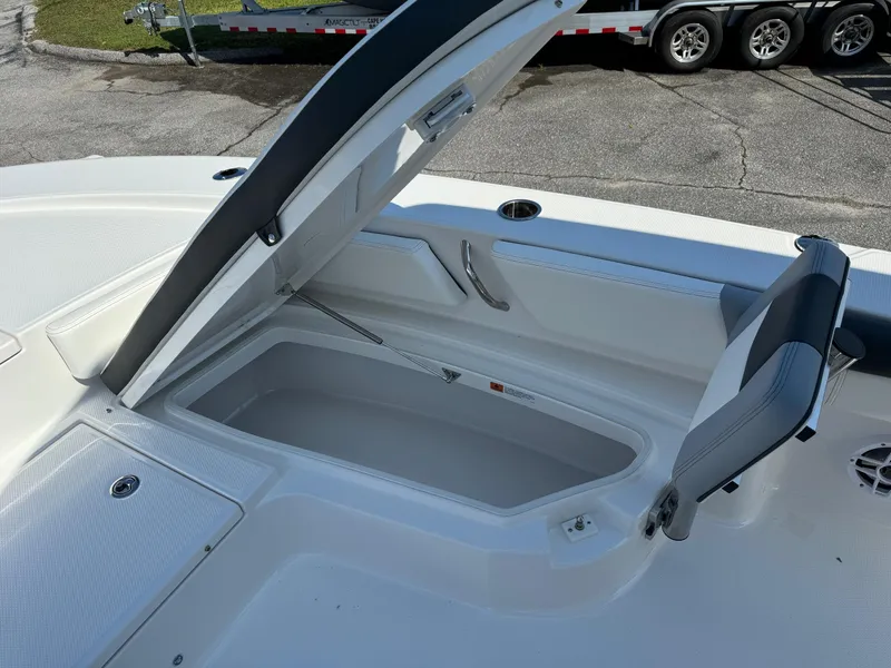 Slide: The Image of 2025 Robalo R246 CAYMAN boat storage compartment open, showcasing spacious interior design. - 8