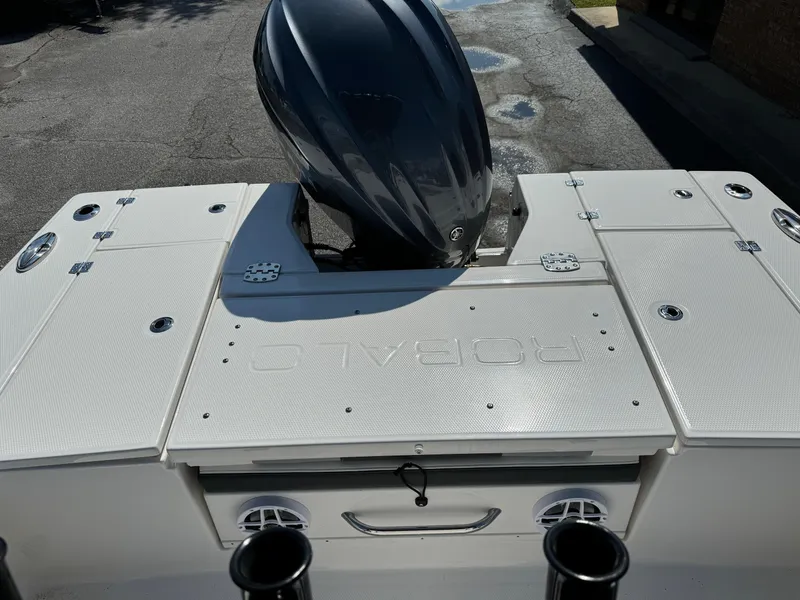 Slide: The Image of 2025 Robalo R246 CAYMAN boat with sleek design and powerful outboard motor. - 13