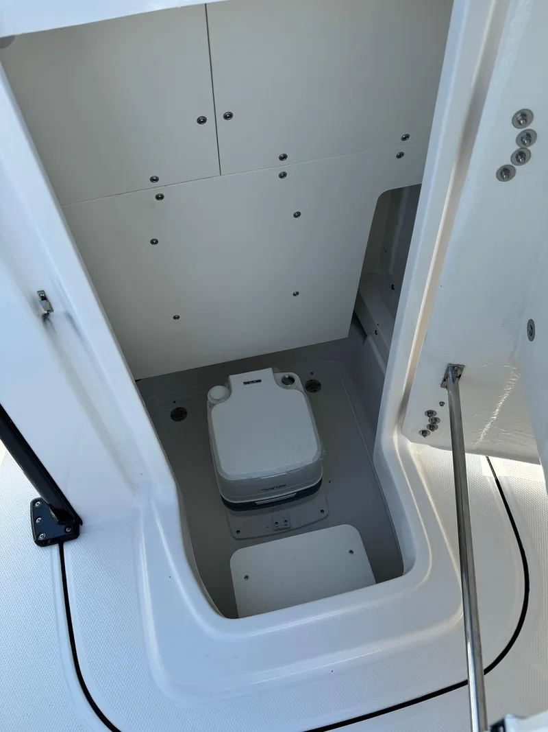 Slide: The Image of 2025 Robalo R246 CAYMAN boat interior with compact marine toilet. - 9