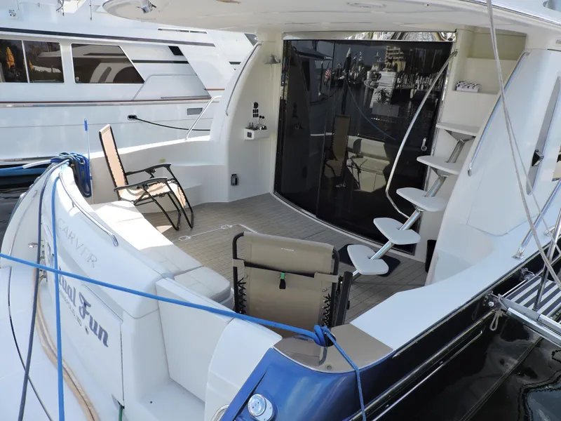 Slide: The Image of 2010 Carver 56 Voyager SE yacht with spacious deck and seating area. - 3