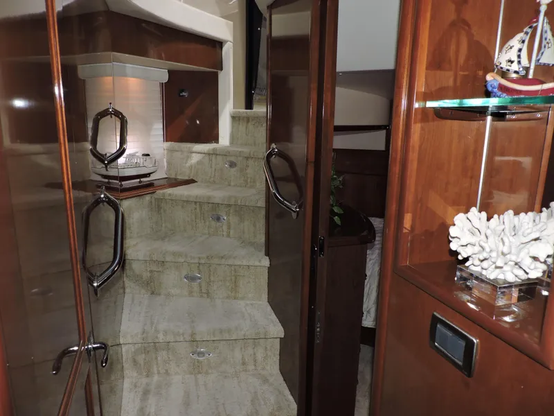 Slide: The Image of Interior staircase of 2010 Carver 56 Voyager SE yacht, featuring elegant wood and decor. - 32