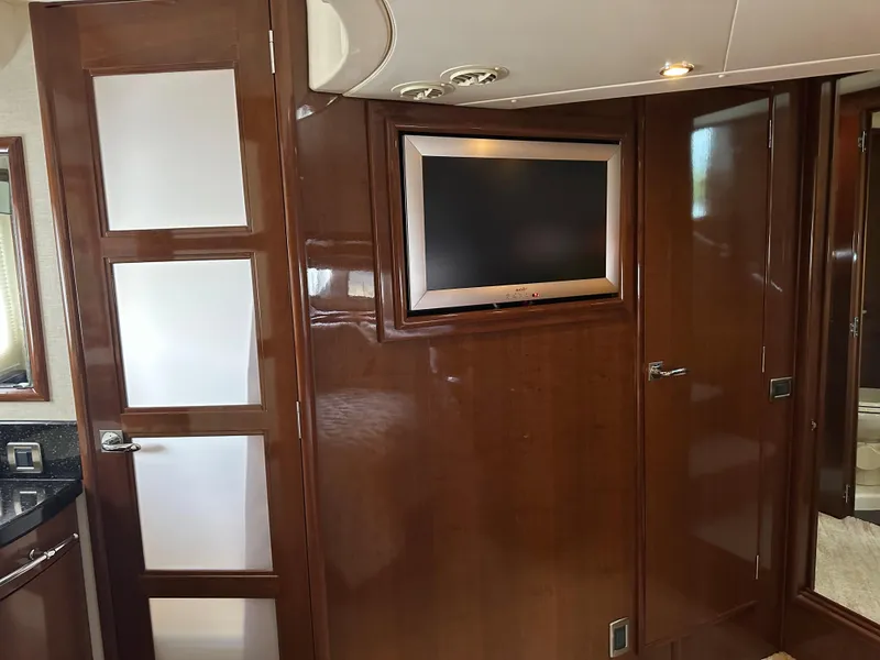 Slide: The Image of Interior of 2010 Carver 56 Voyager SE yacht with wood paneling and built-in TV. - 36