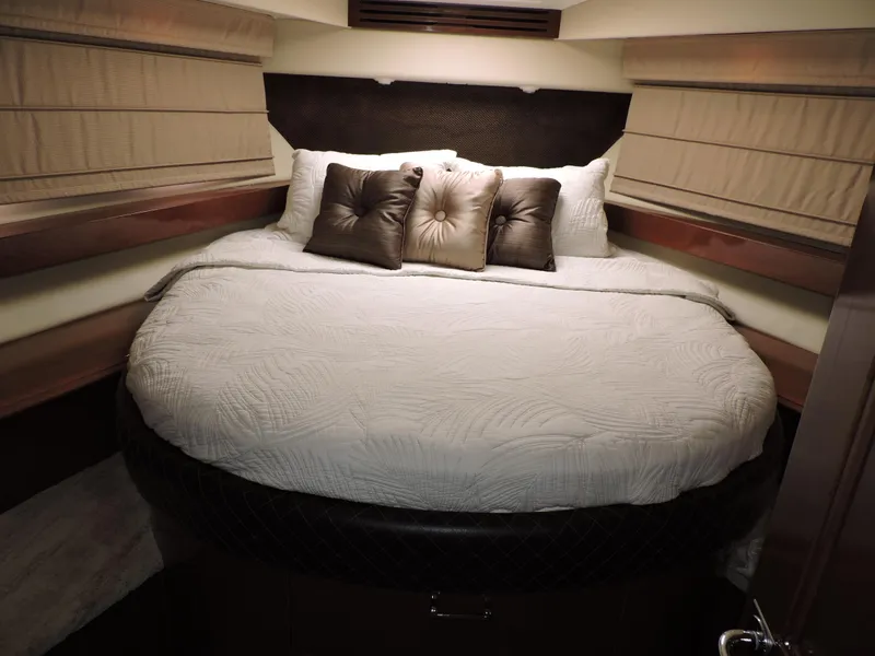 Slide: The Image of Luxurious bedroom in 2010 Carver 56 Voyager SE yacht with plush bedding and pillows. - 42