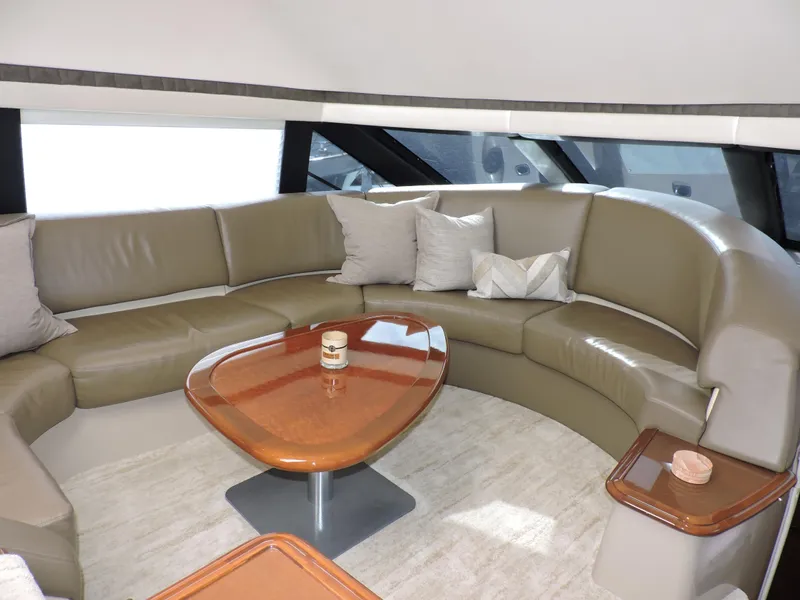 Slide: The Image of Luxurious interior of 2010 Carver 56 Voyager SE yacht with curved leather seating and wooden table. - 23