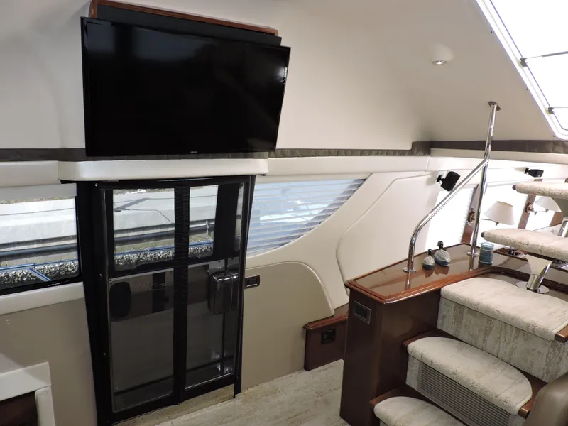 Slide: The Image of Interior of 2010 Carver 56 Voyager SE yacht with TV and staircase. - 28