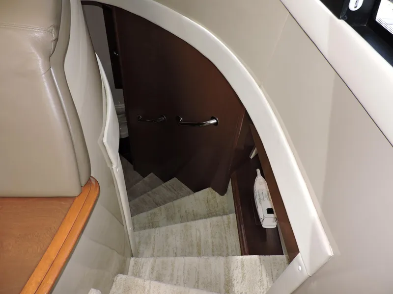 Slide: The Image of Staircase inside 2010 Carver 56 Voyager SE yacht, featuring elegant wood and carpet design. - 30