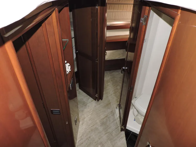Slide: The Image of Interior of 2010 Carver 56 Voyager SE yacht, featuring wooden doors and a compact bathroom. - 31