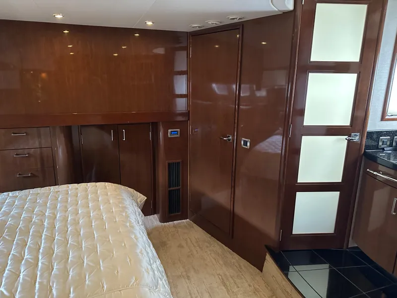 Slide: The Image of Luxurious interior of 2010 Carver 56 Voyager SE yacht with wood paneling and plush bedding. - 34