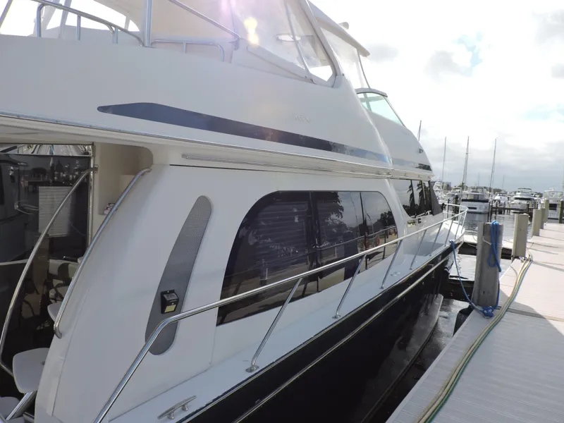 Slide: The Image of 2010 Carver 56 Voyager SE yacht docked at marina, side view. - 4