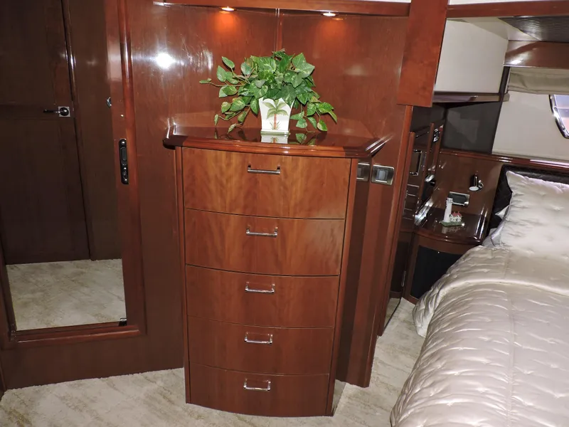 Slide: The Image of Luxurious 2010 Carver 56 Voyager SE bedroom with wooden dresser and elegant bedding. - 41