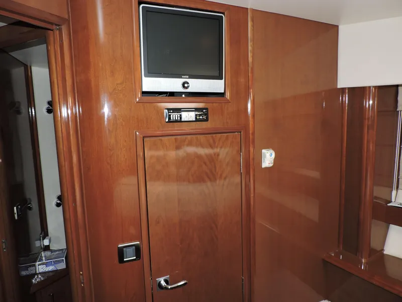 Slide: The Image of Interior of 2010 Carver 56 Voyager SE with wood paneling and mounted TV. - 45