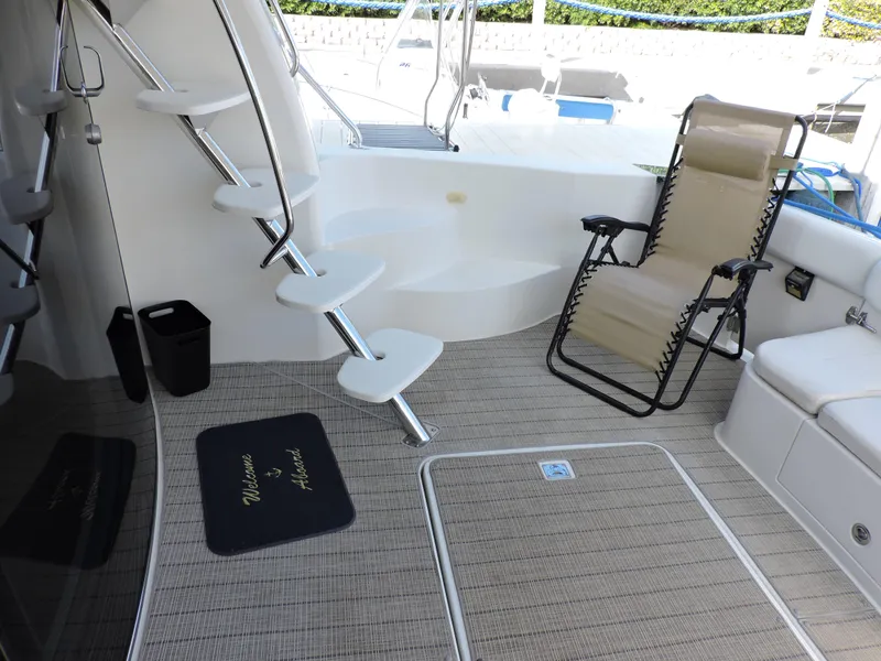 Slide: The Image of 2010 Carver 56 Voyager SE yacht deck with chair and stairs. - 6