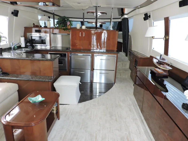 Slide: The Image of Luxurious interior of 2010 Carver 56 Voyager SE yacht with modern kitchen and elegant wood finishes. - 8