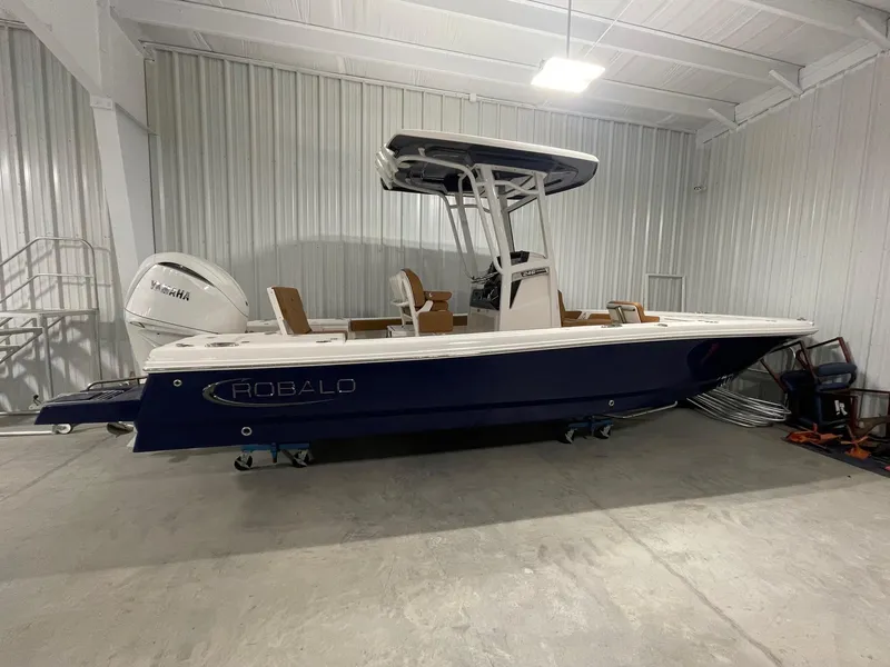 Slide: The Image of 2025 Robalo 246 Cayman boat in a storage facility, featuring a Yamaha engine. - 16