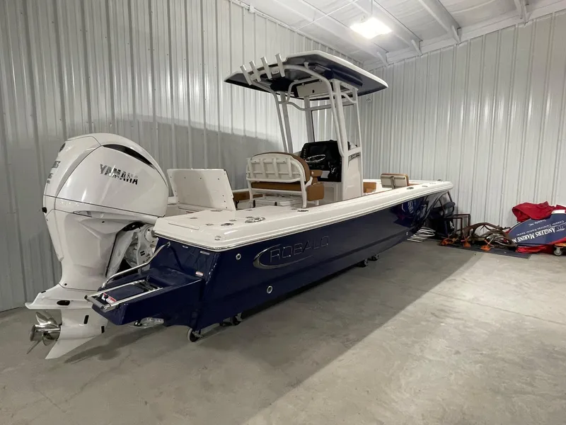Slide: The Image of 2025 Robalo 246 Cayman boat with Yamaha engine in a storage facility. - 4