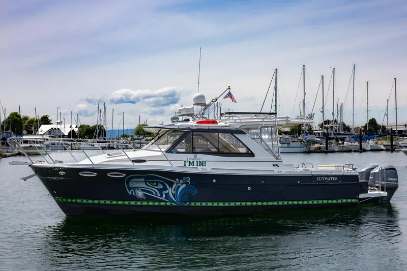 The Image of 2017 Cutwater C-302 Sport Coupe boat docked in marina, featuring custom graphics. - 0