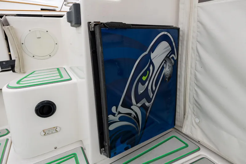 Slide: The Image of 2017 Cutwater C-302 Sport Coupe interior with custom Seahawks-themed panel design. - 10