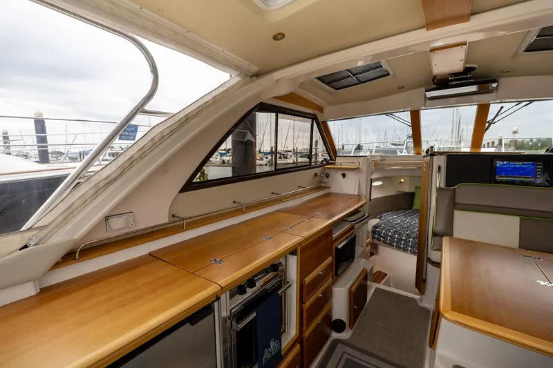 Slide: The Image of Interior of 2017 Cutwater C-302 Sport Coupe, featuring wood finishes and modern amenities. - 13