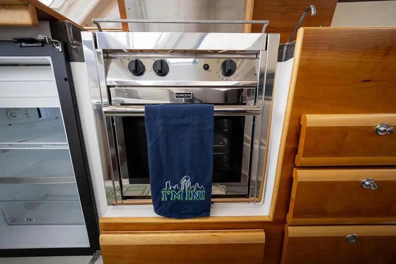 Slide: The Image of Stainless steel oven in 2017 Cutwater C-302 Sport Coupe kitchen with blue towel. - 18