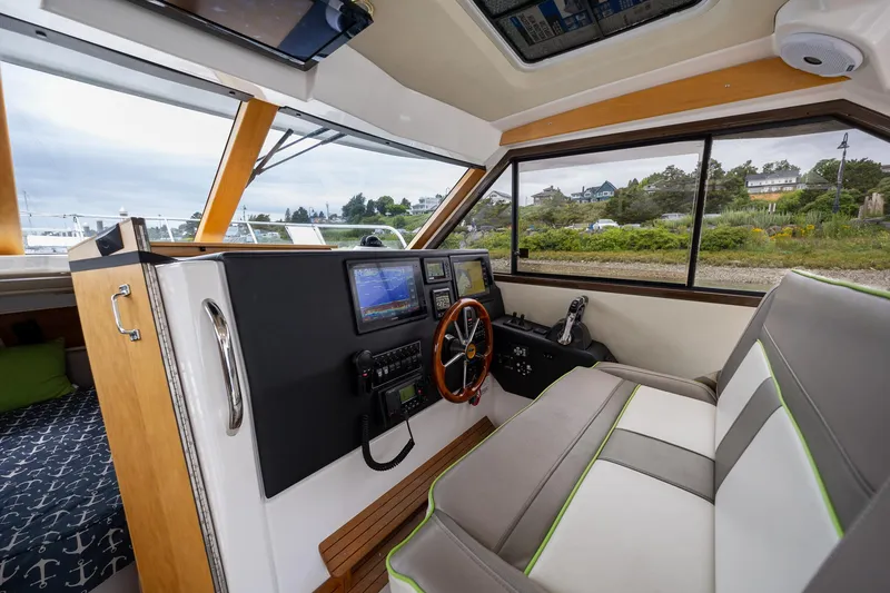 Slide: The Image of Interior of 2017 Cutwater C-302 Sport Coupe boat with modern navigation equipment and seating. - 22