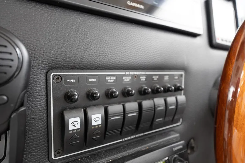 Slide: The Image of 2017 Cutwater C-302 Sport Coupe dashboard with control panel and switches. - 24