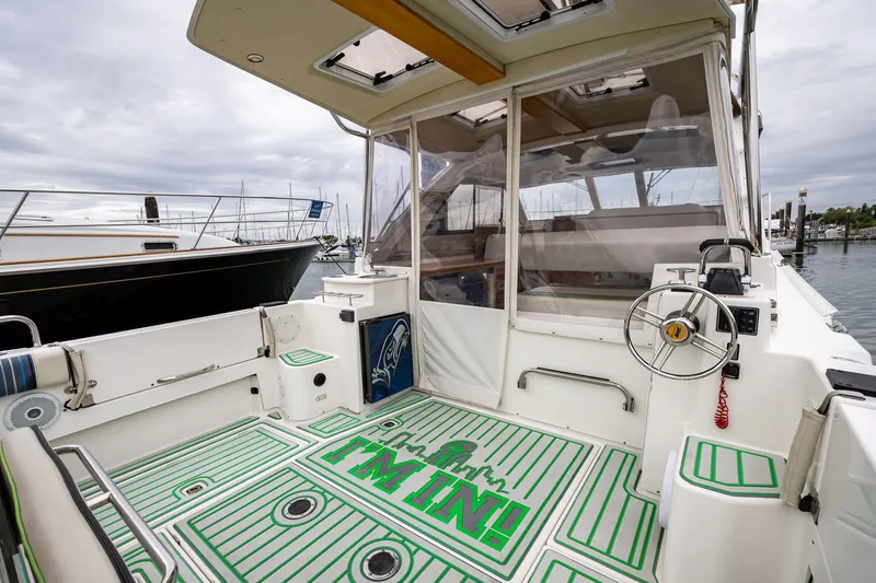 Slide: The Image of 2017 Cutwater C-302 Sport Coupe boat interior with steering wheel and custom flooring. - 4