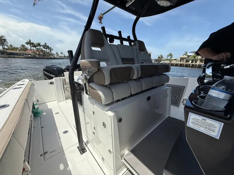 Slide: The Image of 2020 Blackfin 332 CC boat interior with seating and console, cruising on a sunny day. - 10