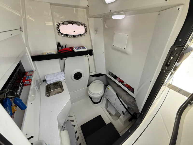 Slide: The Image of 2020 Blackfin 332 CC boat interior with compact bathroom and storage. - 12