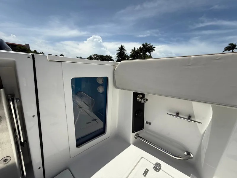 Slide: The Image of 2020 Blackfin 332 CC boat interior with sleek white seating and stainless steel accents. - 14