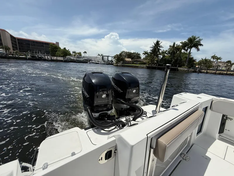Slide: The Image of 2020 Blackfin 332 CC boat with dual outboard engines on a sunny day. - 16