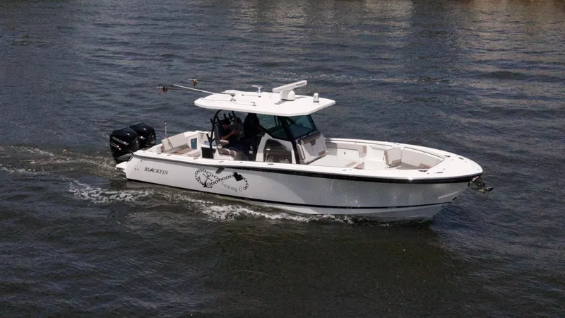 Slide: The Image of 2020 Blackfin 332 CC boat cruising on water, side view. - 2