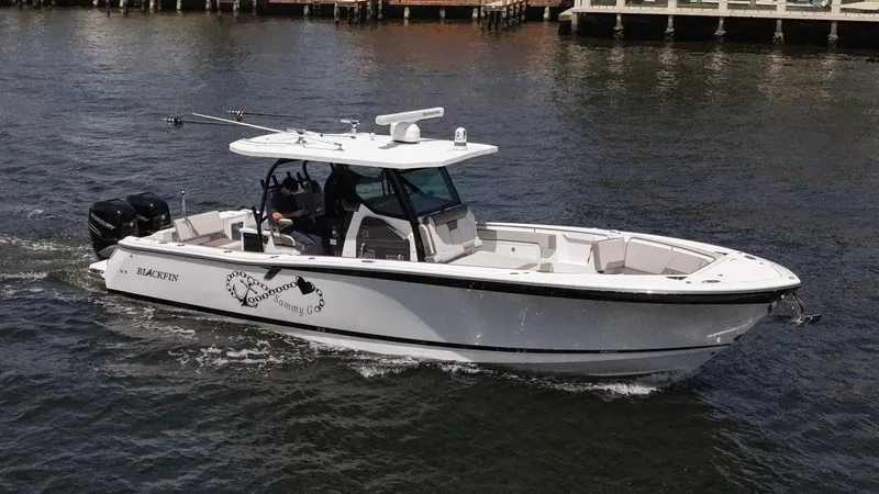 Slide: The Image of 2020 Blackfin 332 CC boat cruising on water, side view. - 4