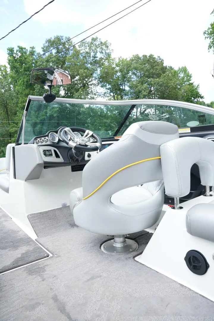 Slide: The Image of 2014 MasterCraft X-25 boat interior with sleek dashboard and comfortable seating. - 13