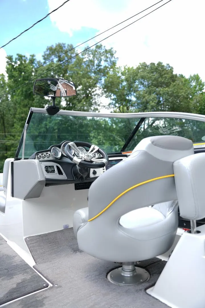 Slide: The Image of 2014 MasterCraft X-25 boat interior with steering wheel and gray seating. - 15