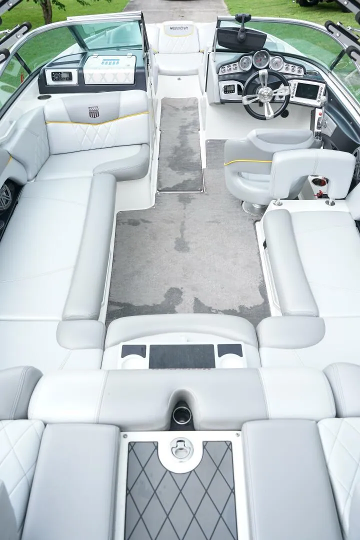 Slide: The Image of 2014 MasterCraft X-25 boat interior with sleek seating and modern dashboard. - 21