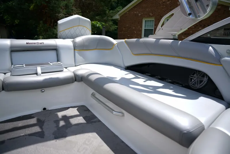 Slide: The Image of 2014 MasterCraft X-25 boat interior with gray and yellow-accented seating. - 23