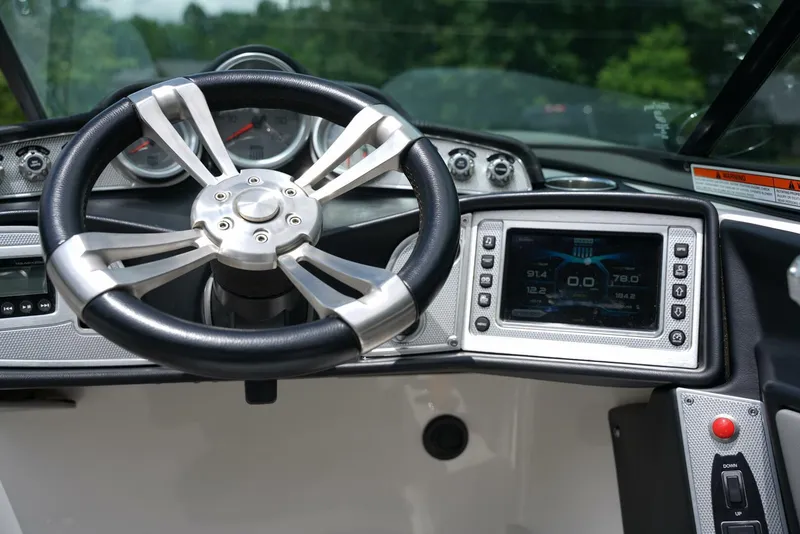 Slide: The Image of 2014 MasterCraft X-25 dashboard with steering wheel and digital display. - 17